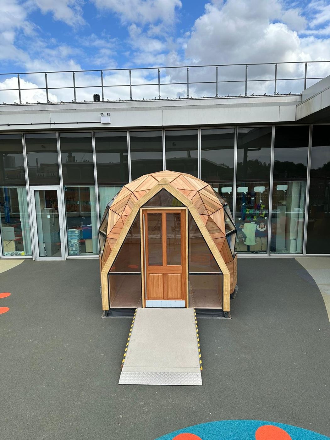 The glazed gable entrance and ramp, viewed head-on