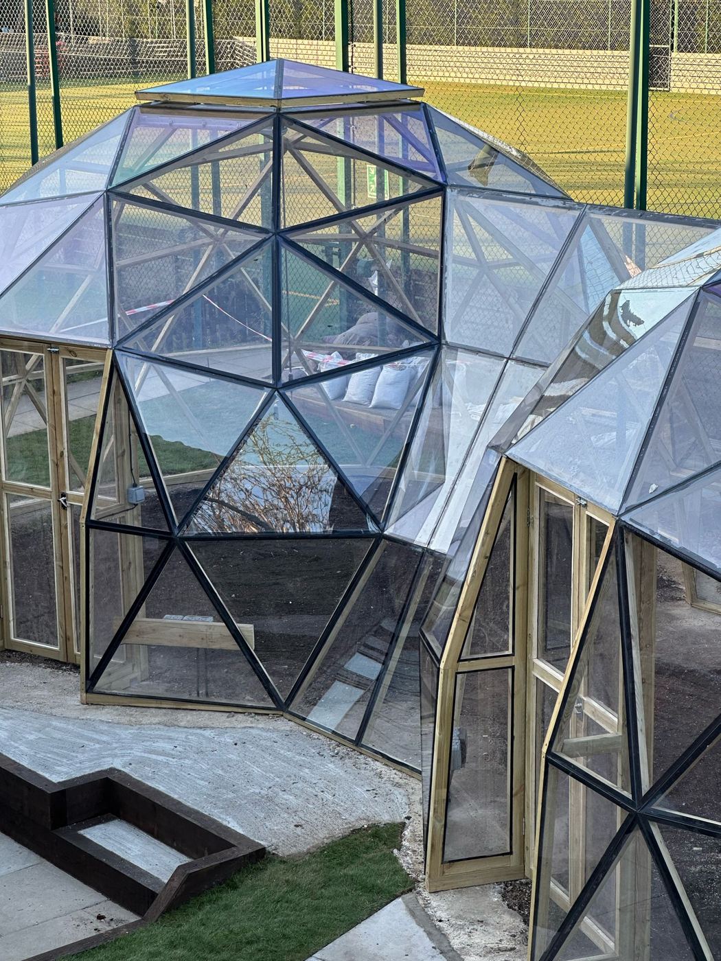 Twin 5.5m glazed geodesic domes joined by a timber-framed link tunnel at Milton Keynes Preparatory School